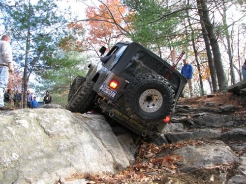 Jeep navigating rocky terrain, off-road