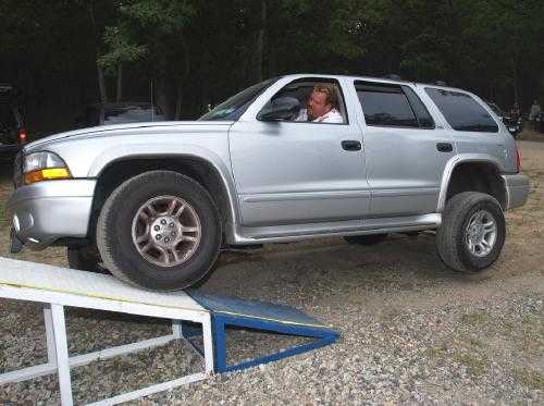 Man driving silver SUV up ramp