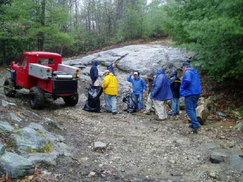 Volunteers collecting trash at trailhead