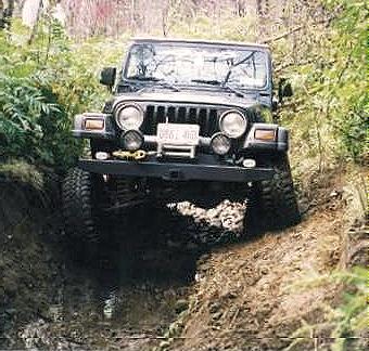 Jeep navigating challenging off-road terrain