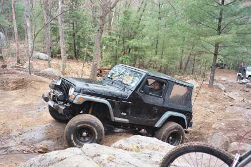 Black Jeep Wrangler on rocky trail