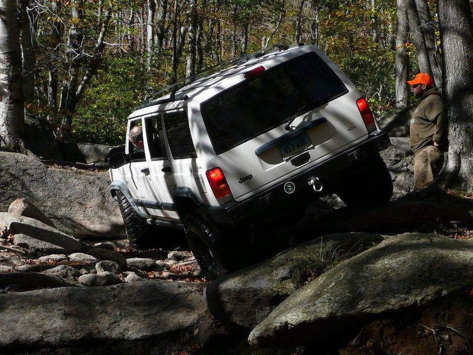 White Jeep Cherokee traversing rocky terrain