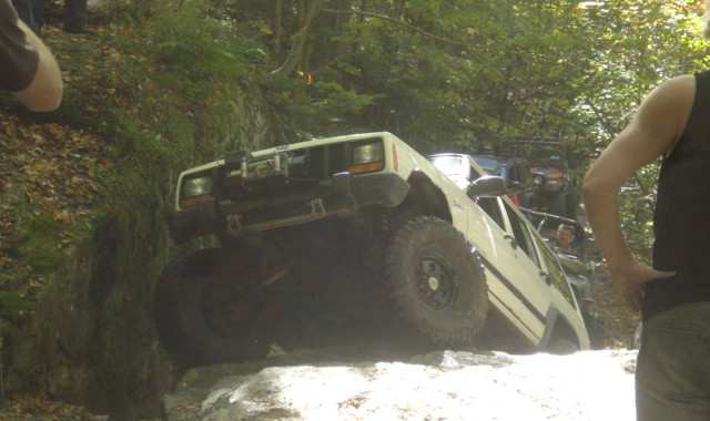 White Jeep navigating rocky terrain