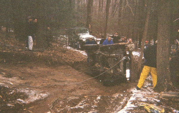 Off-roaders winch Jeep through mud