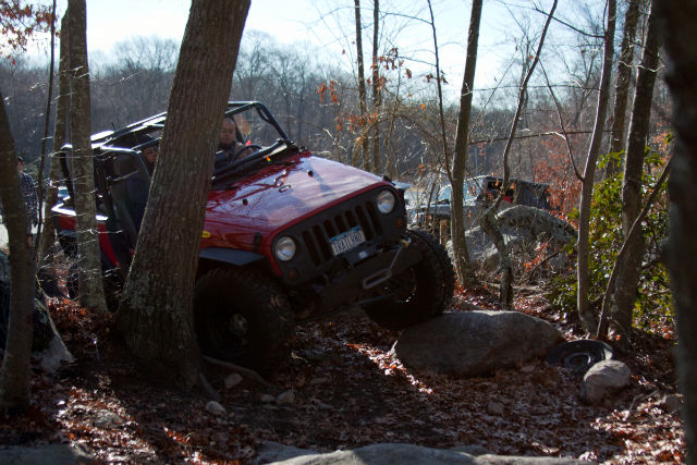 Red Jeep navigating rocky trail