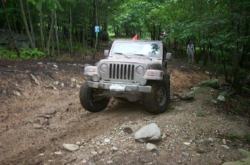 Jeep navigating muddy off-road trail
