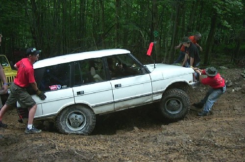 White Range Rover stuck in mud, off-roading