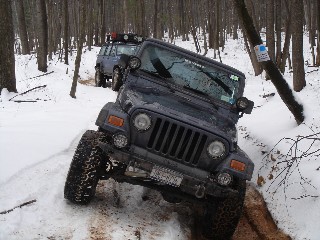 Jeep Wrangler navigating snowy trail