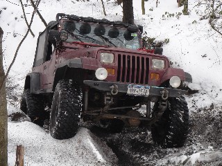 Jeep traversing snowy terrain