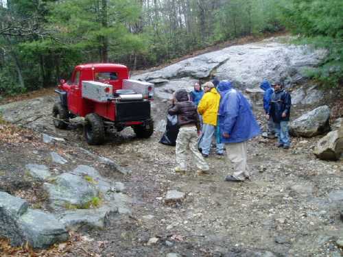 Red truck and people near rocks