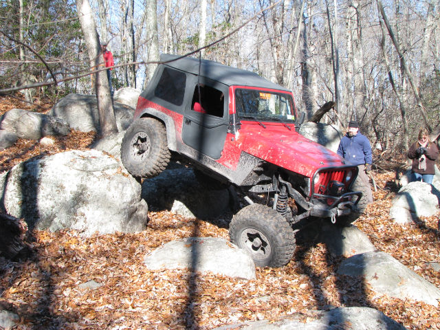 Red Jeep navigating rocky terrain, Long Island Off Road