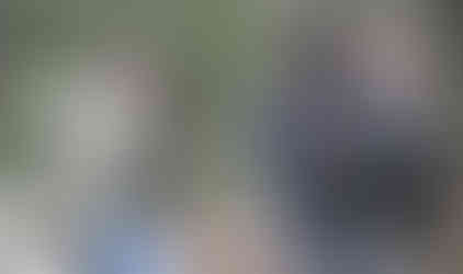 Men gathered in a wooded area