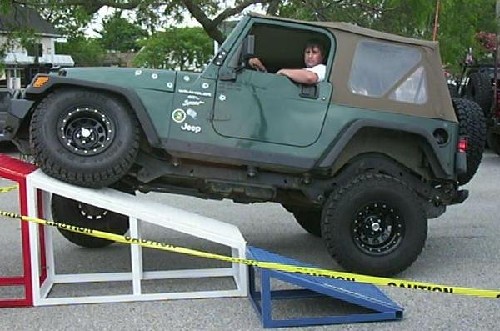 Person driving Jeep up ramp; Long Island Off Road