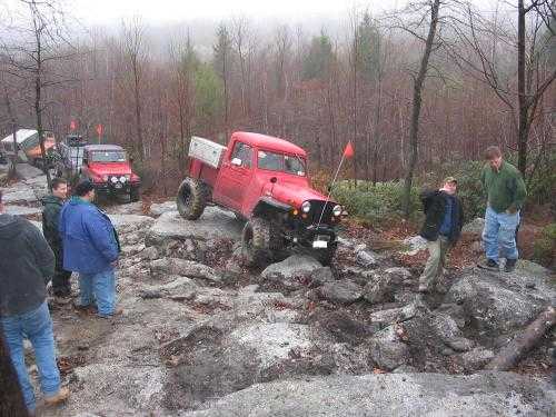 Red Jeep navigating rocky terrain, Long Island Off Road