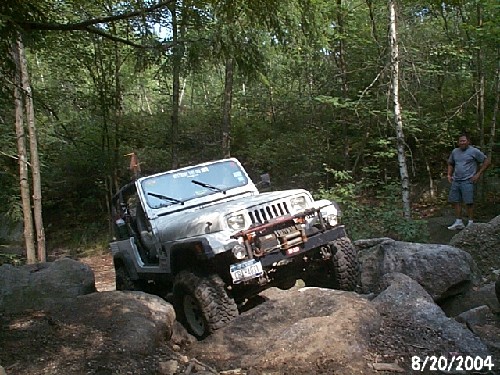 Silver Jeep navigating rocks, Long Island Off Road