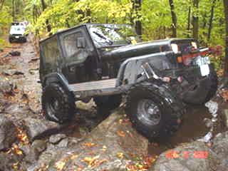 Black Jeep navigating rocky terrain