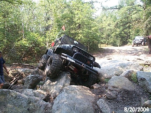 Black Jeep navigating rocky terrain