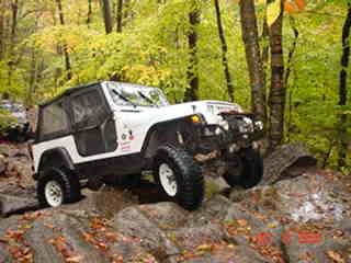 White Jeep navigating rocky trail