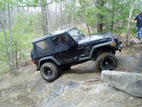 Black Jeep navigating rocky terrain