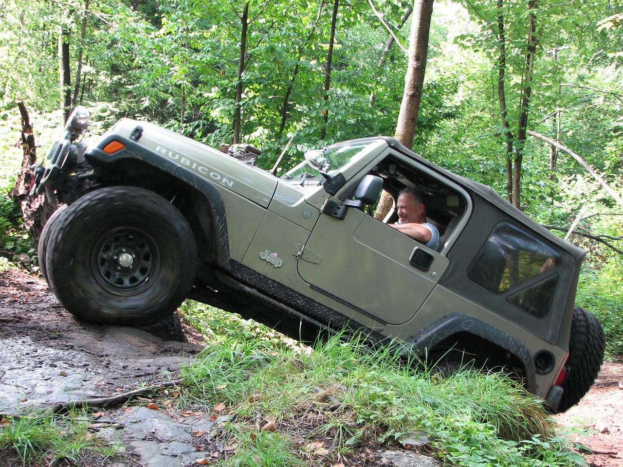 Man driving Jeep Wrangler on trail