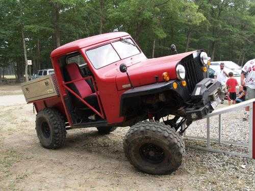Red Jeep truck modified for off-roading