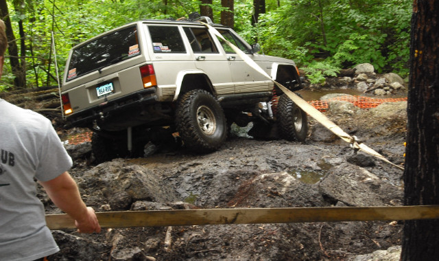 Jeep crossing rocky stream