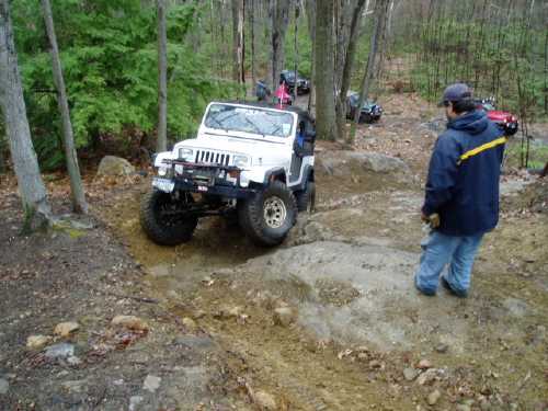 White Jeep navigating rocky terrain