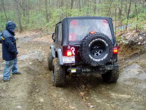 Jeep traversing muddy trail