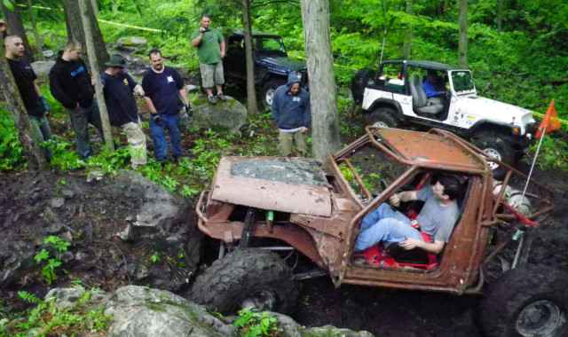 Off-road vehicle stuck, spectators watching