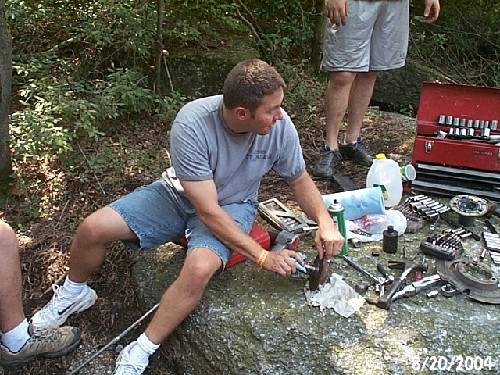 Man repairing equipment outdoors