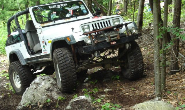 White Jeep navigating rocky trail