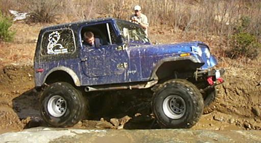 Muddy blue Jeep CJ, off-roading