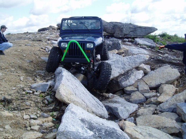 Blue Jeep navigating rocky terrain