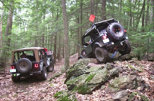 Two Jeeps off-roading on rocky trail