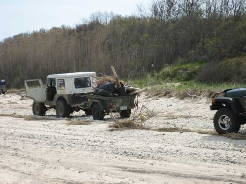 Off-road vehicle hauling trash, Long Island