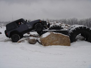 Jeep navigating snowy off-road obstacle course