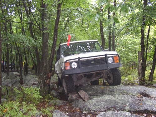 White Range Rover navigating rocky terrain