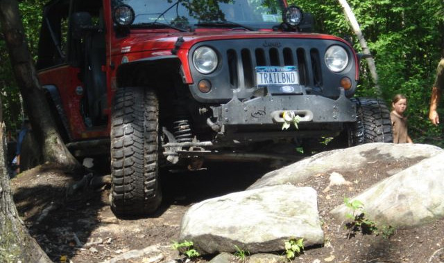 Red Jeep navigating rocks, Long Island Off Road