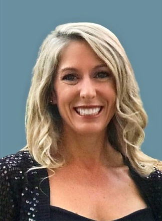 This is a picture of Meghan. She is smiling, has longer blond hair, and is works behind the scenes helping Brandon the owner.