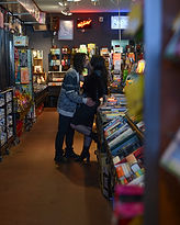Alexis and Chad browsing vintage vinyl records during their lifestyle engagement photography session