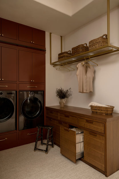 Luxury residential interior design in North County San Diego by Rose Lake Design featuring a custom kitchen with tailored neutral cabinetry and integrated appliances, an adjacent wet bar with custom millwork and stone countertops, a built-in breakfast nook with upholstered banquette seating, a refined living room with custom furnishings and layered textures, a sophisticated powder bathroom with designer fixtures and elevated stone finishes, a thoughtfully designed laundry room with integrated storage solutions, and a fully customized walk-in pantry with floor-to-ceiling cabinetry, all unified through cohesive architectural detailing and refined material selections.