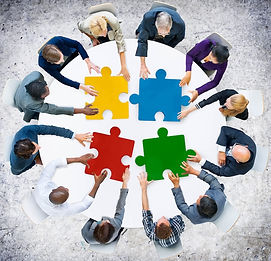 A group of people holding puzzle pieces