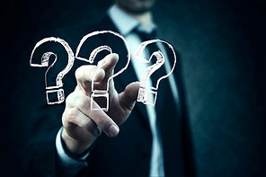 A person pointing at a question marks