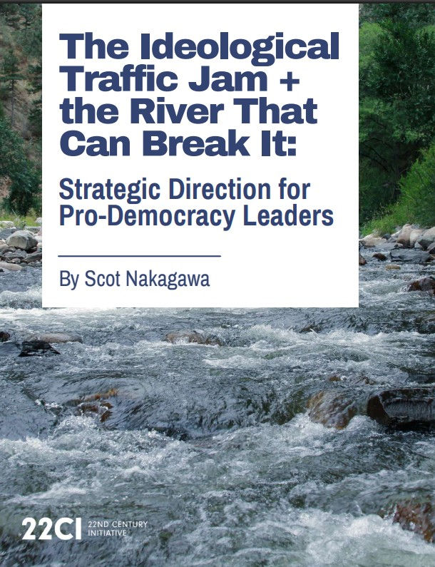 A rushing river flows over rocks through a lush green landscape.