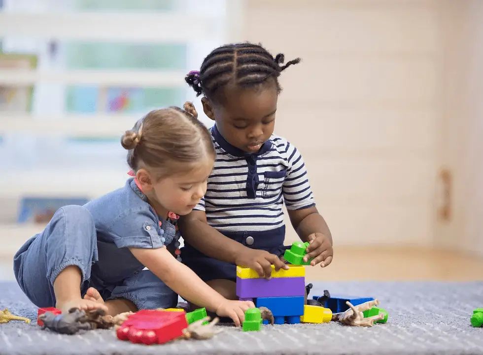 children-girls-blocks-playing-sharing-child-care.webp