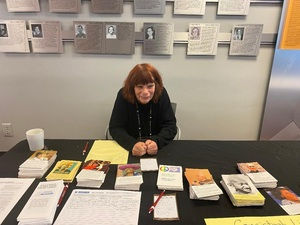 CLN Board member Lisa Stiller at CLN table at Social Action Summer Institute