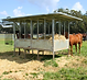 Side view of a Quast Metal extra-high roofed hay feeder for taller horses