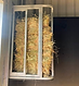 Custom stable hay feeder designed to hold a small rectangular hay bale.
