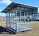 Front view of a Quast Metal large square-bale feeder with the roof folded down for transport