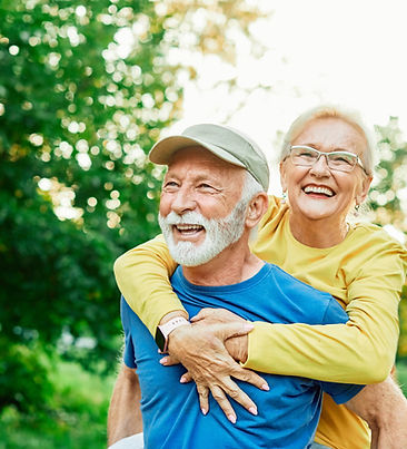 Smiling active senior couple having fun together in the park, active healthy elderly peop